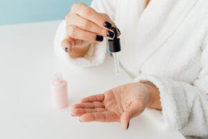 woman applying serum on hand