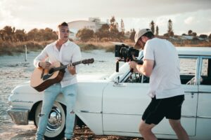 recording person playing guitar